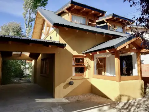 Casa de cinco ambientes (en dos plantas), con quincho / cochera y entrada pasante de autos con jardín libre.